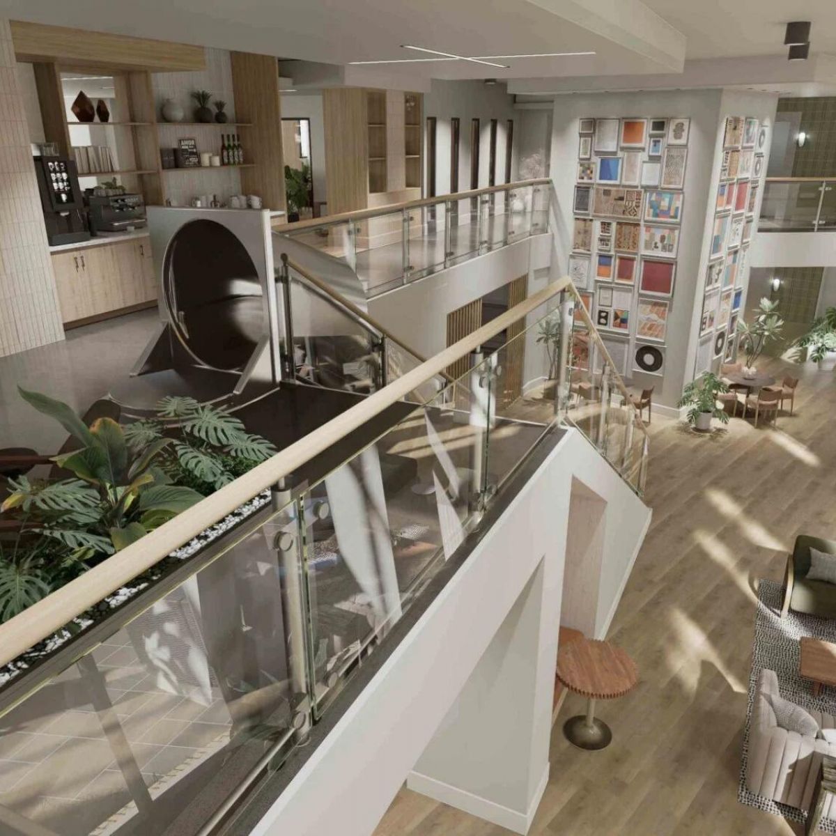 114 Earle Student Living Apartments An aerial view of a multi-level lobby with a central staircase, seating areas, and a wall of framed art.
